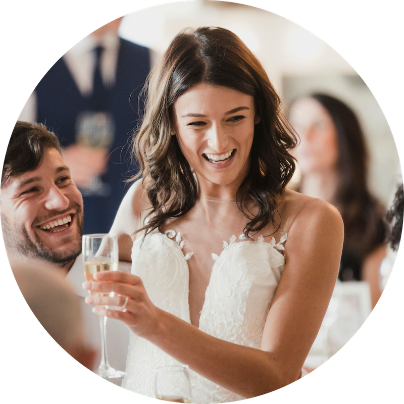 A happy bride holding a glass of Champaign
